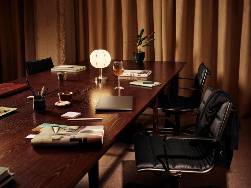 Meeting room at The Hoxton with a wooden table and leather chairs